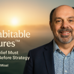 Portrait of Morris Misel smiling in front of a misty sunrise horizon with the article title "Inhabitable Futures™ – Why Belief Must Come Before Strategy" and his name displayed in modern, clean typography.