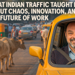 Morris Misel driving a yellow Indian taxi through chaotic Delhi traffic, surrounded by tuk-tuks, cows, pedestrians, and multi-lane flow beyond road markings; text reads “What Indian Traffic Taught Me About Chaos, Innovation, and the Future of Work.
