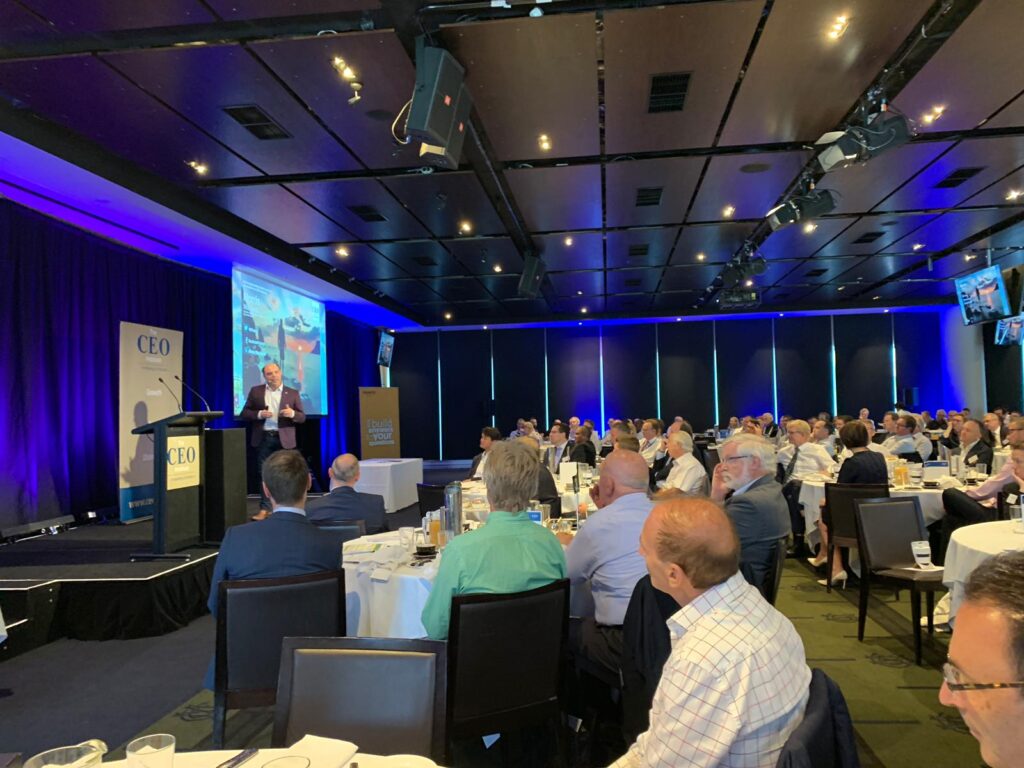 Morris Misel delivering a keynote presentation on stage.